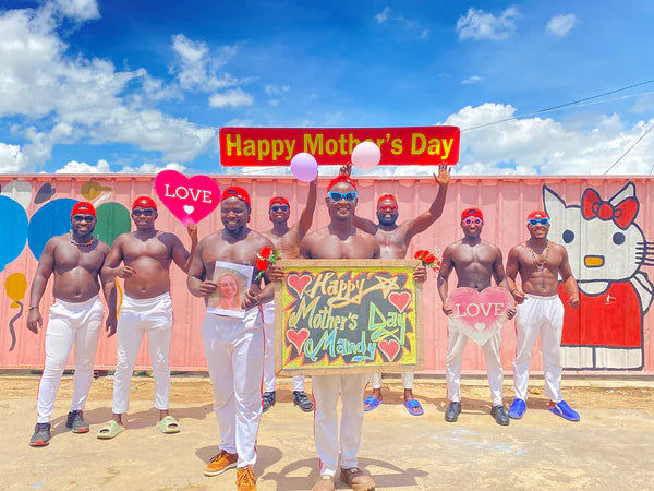 Group of muscular African men holding a personalized sign for a Mother's Day video gift